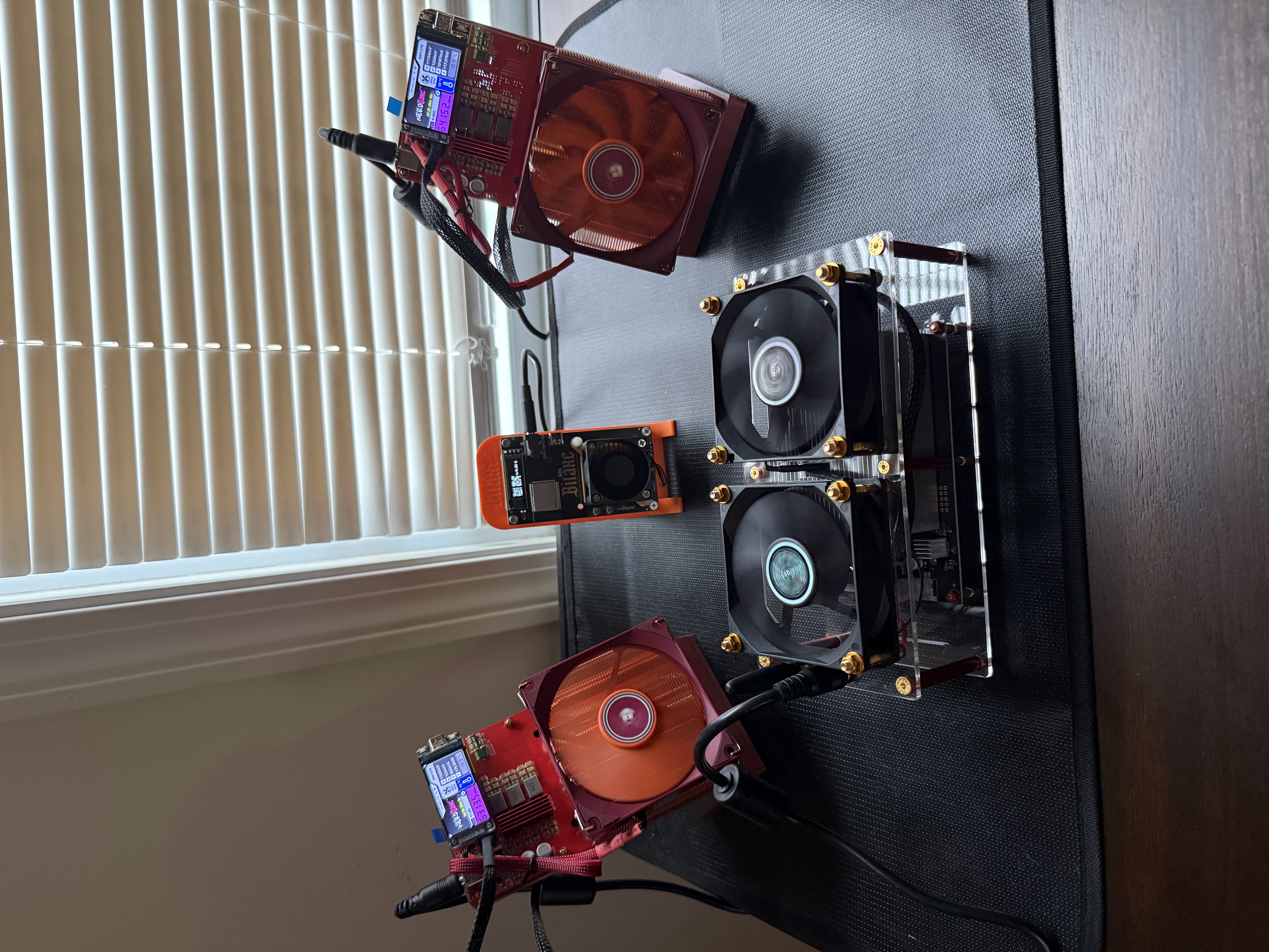 Bitaxe Hex running alongside two NerdQaxe++ Remastered units and a Bitaxe Gamma on Mike's desk.